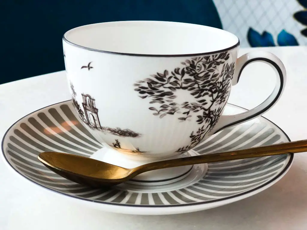 pretty grey and white china tea cup on saucer