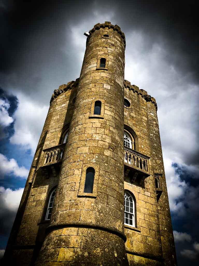 broadway tower in front of a moody sky