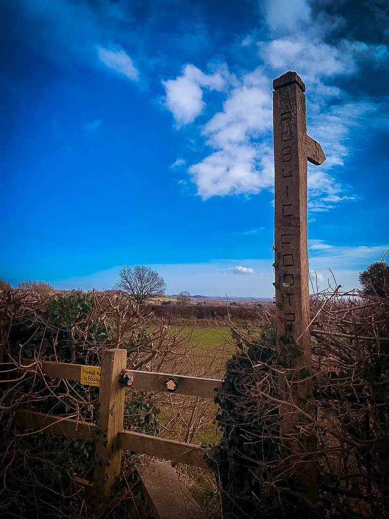 wooden stile and footpath sign in yoxall