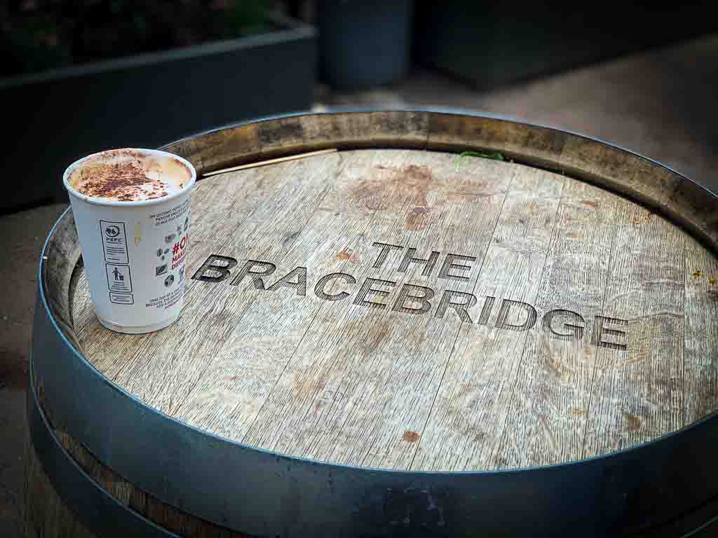 take out coffee on top of a barrel which says the bracebridge