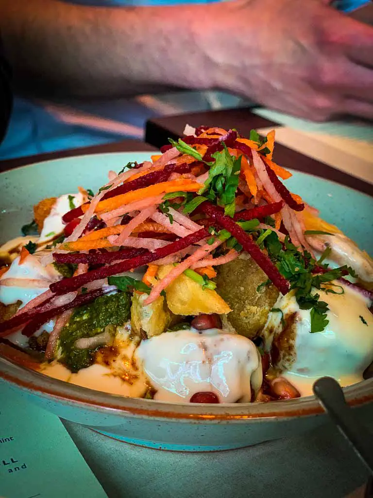 bowl of colourful vegan house chaat from dishoom