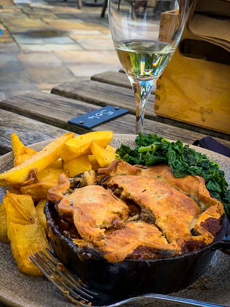 Steak pie with a side of Kale and chinky chips