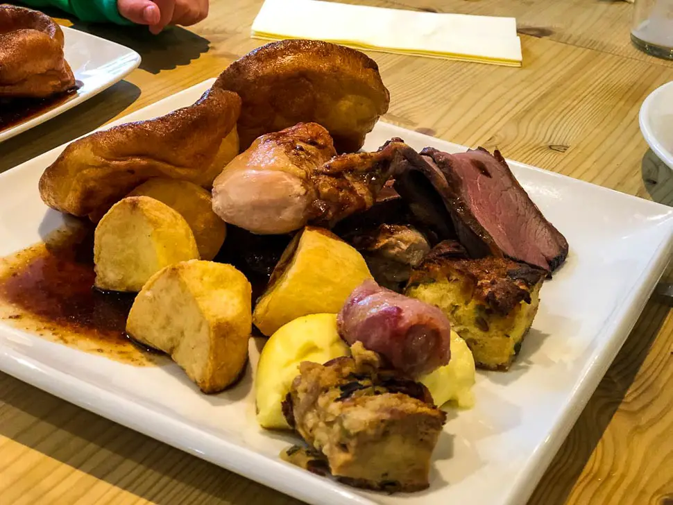 huge plate of roast beef, roast potatoes, yorkshire pudding and vegetables