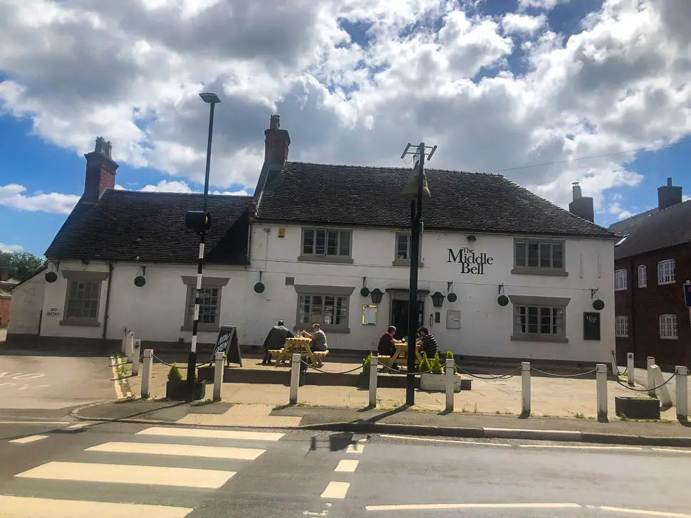 view across a zebra crossing of the middle bell pub in barton under need wood