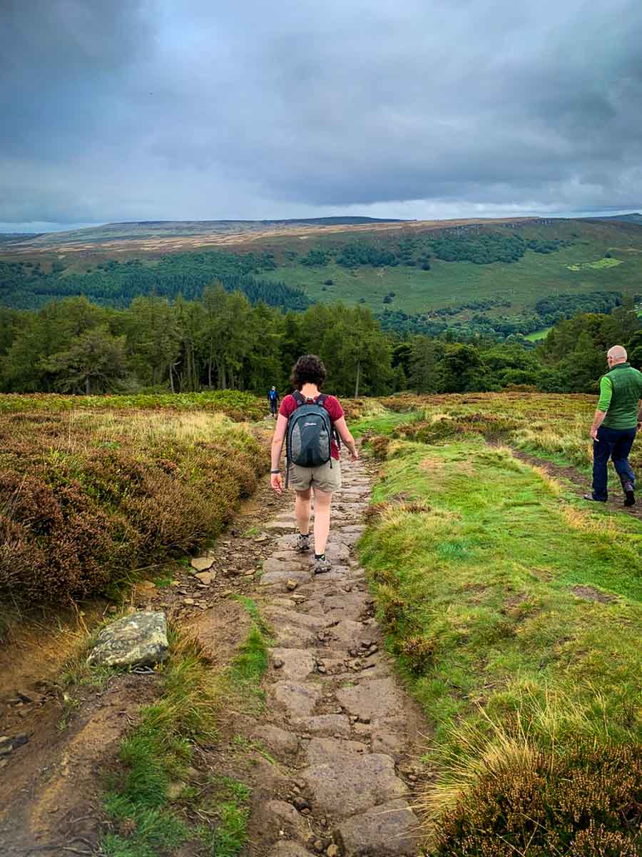 woman with backpack hiking down win hill